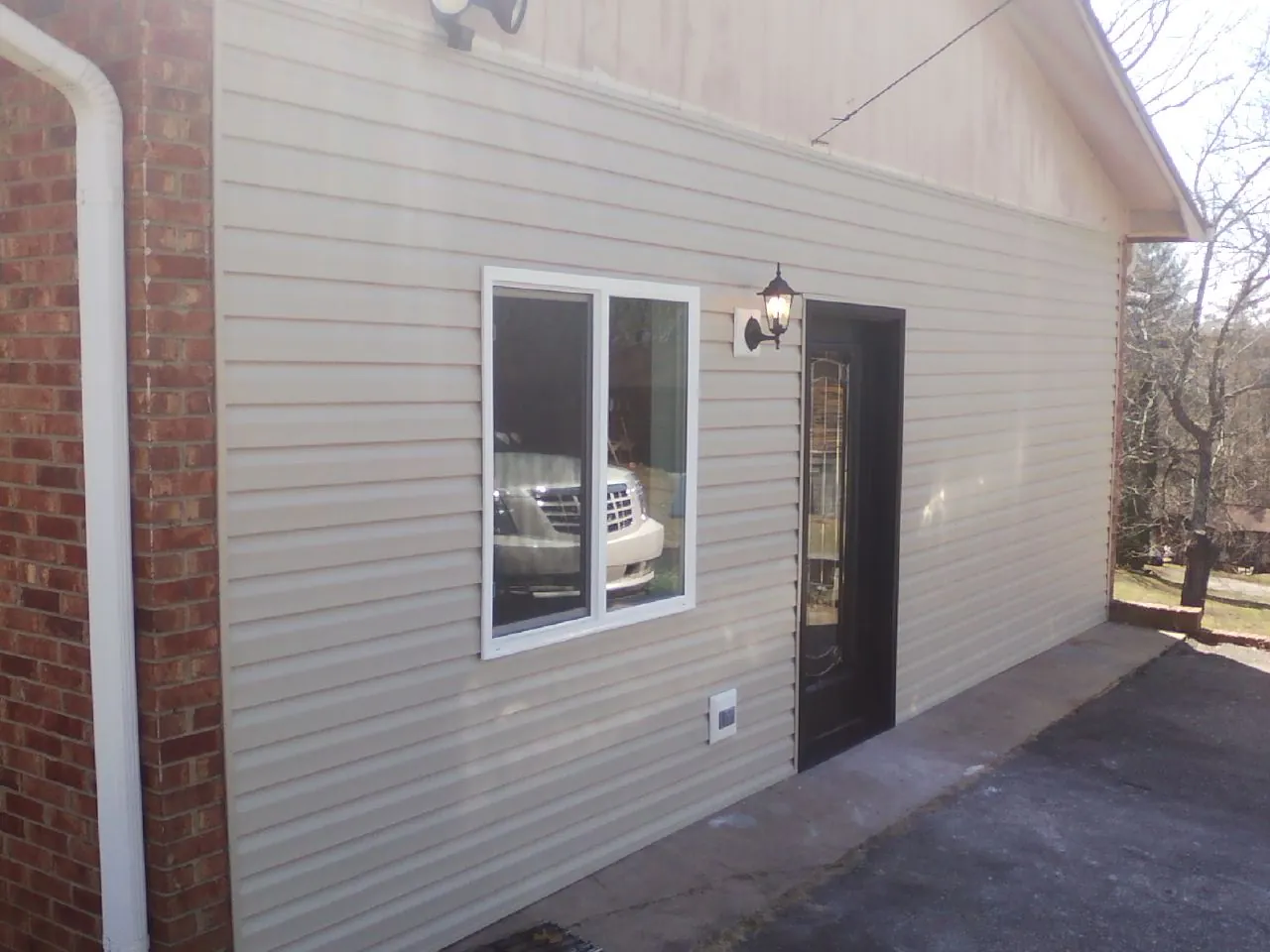 New vinyl siding and entry door on a room addition in Demorest