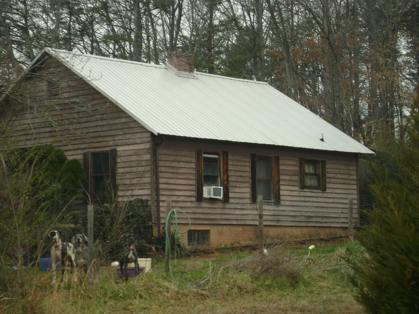 White metal roof on an old wood sided farmhouse, from a Metal Roof Installation job in Demorest